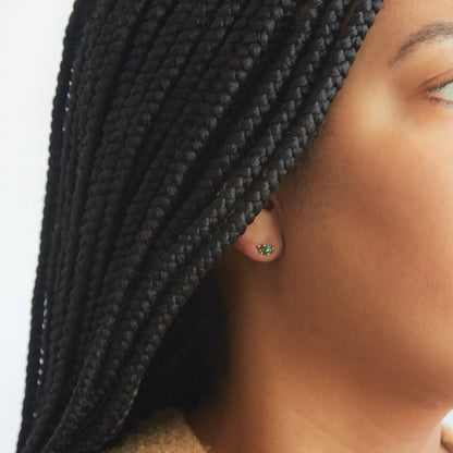 Green triple baguette CZ stud earrings in gold, worn on ear with a minimal, everyday jewelry aesthetic.