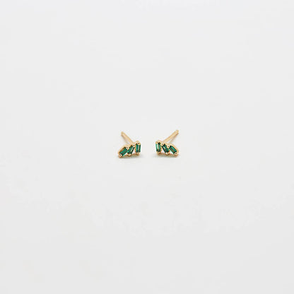 Green triple baguette CZ stud earrings in gold, worn on ear with a minimal, everyday jewelry aesthetic.