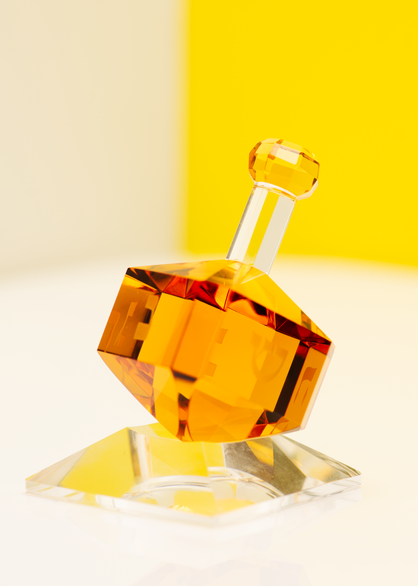 Luxury amber dreidel on clear base, elegant Jewish holiday tabletop decor