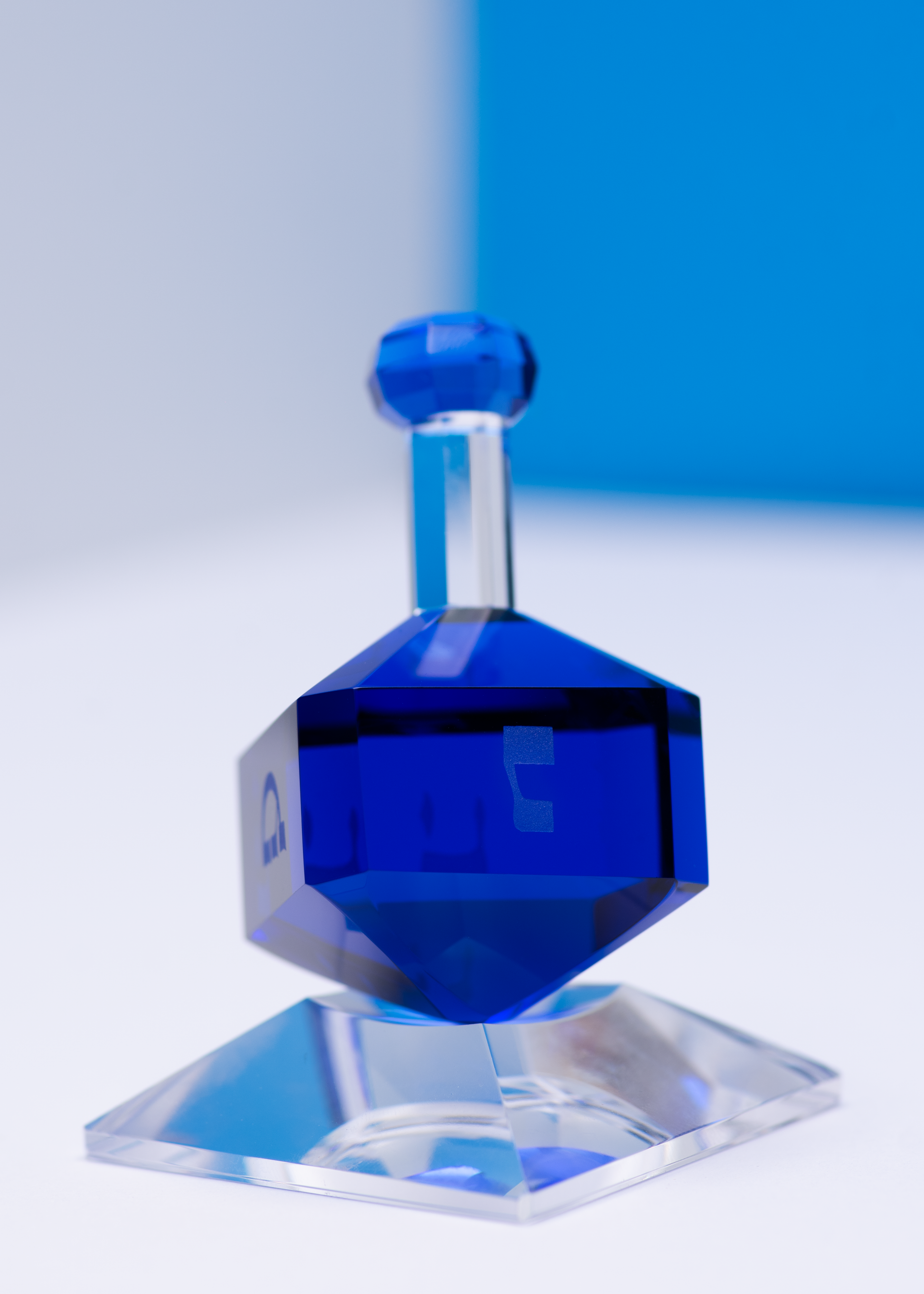 Luxury blue dreidel on clear base, elegant Jewish holiday tabletop decor